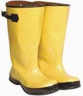 Yellow rubber slush boots with black soles and straps.
